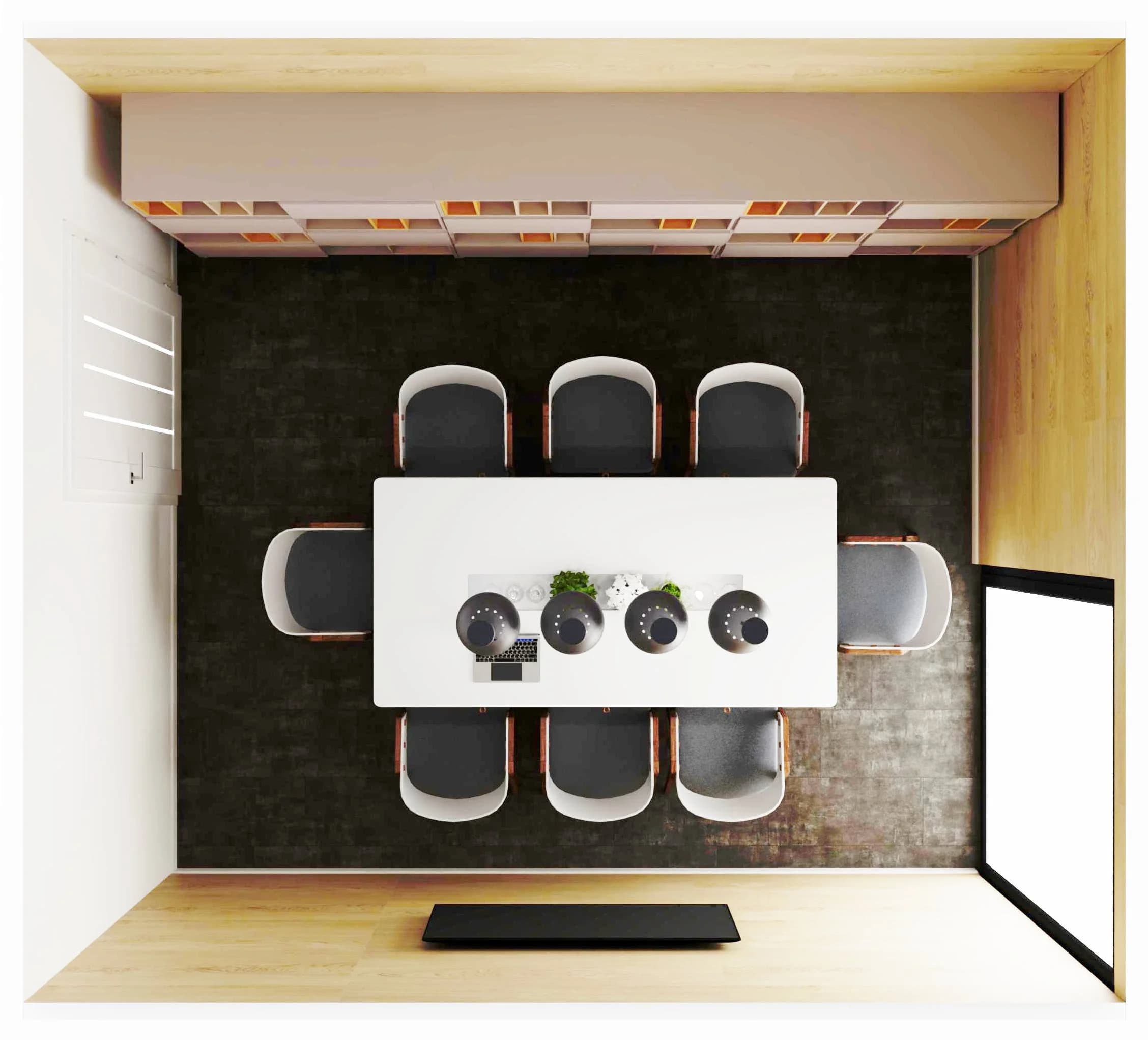 Niewielka salka konferencyjna z dużym stołem i tv