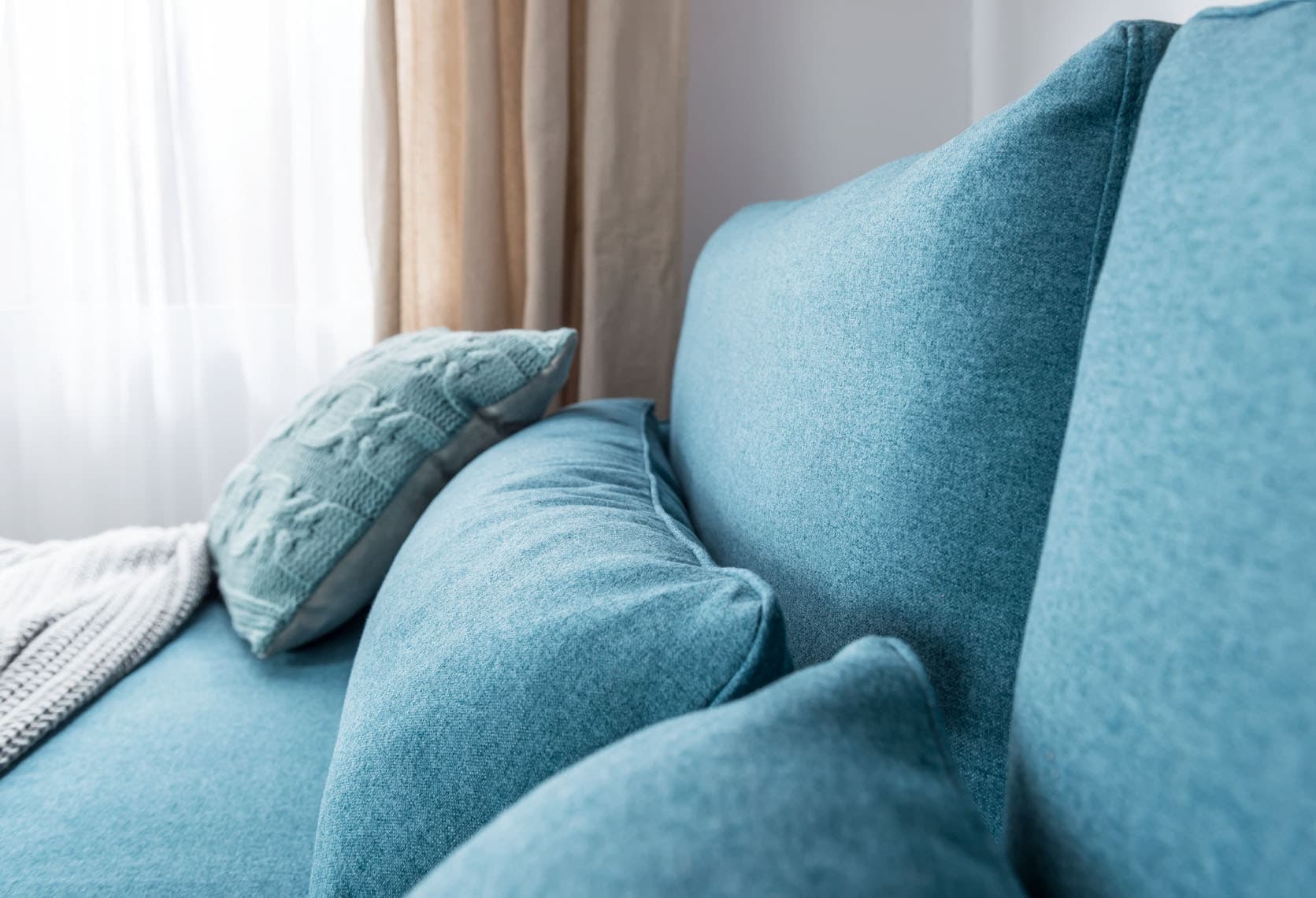 Niebieskie poduszki na niebieskiej kanapie